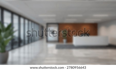 Spacious office lobby featuring large windows, a reception desk, and a welcoming atmosphere. The interior design is modern and professional.