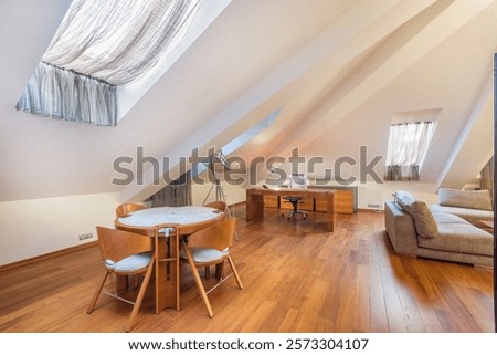 Spacious private attic with curtained windows. Light walls, parquet floor. Upholstered sofas, tables and chairs made of wood.