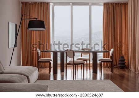 Spacious room with a designer dining table, chairs and interior decor