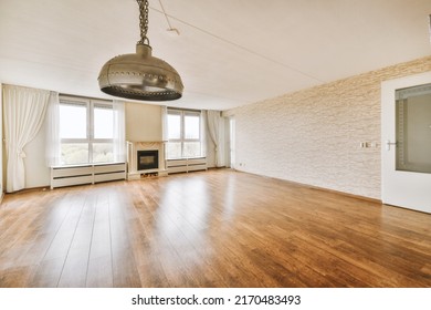 Spacious room with electric fireplace, curtained windows, parquet floors and chandelier