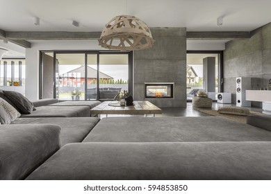 Spacious room with wide couch and patio entrance - Shutterstock ID 594853850