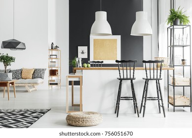 Spacious, Rustic Living Room With Bar Stools And Black Designer Lamp Above Table With Small Tree