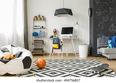 Spacious Schoolboy Room With Window, Soccer Sack Chair, Pattern Carpet, Chalkboard, Sofa, Chair, Desk, Computer And Wall Regale