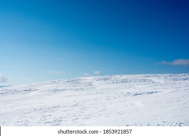 Spacious Snowfield And Blue Sky
