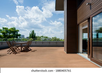 Spacious terrace with wooden floor and furniture, and amazing view