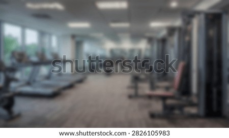 Spacious and well-lit gym interior featuring rows of treadmills and various weight training equipment for a comprehensive workout.