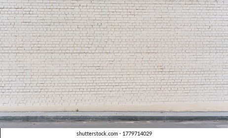 Spacious White Empty Brick Cracked Wall Background On Sidewalk Of City Street Mockup