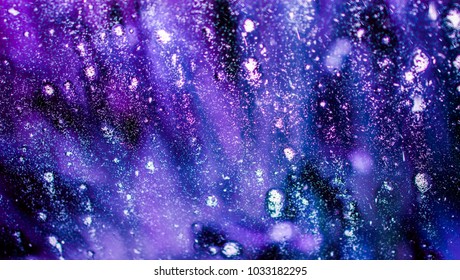 Spacy dreamy blue, purple, black, white car wash soap and bubbles on a window making a spectacular background
