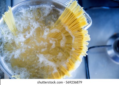 Spaghetti boiling in hot water on the stove