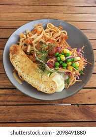 Spaghetti Bolognaise With Salad, Mayonaise Sauce And Garlic Bread.