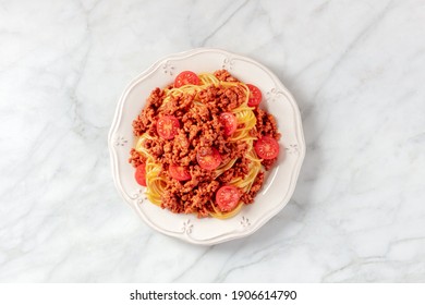 Spaghetti Bolognese, Overhead Shot On A White Marble Background