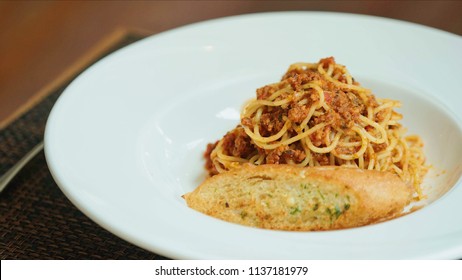 Spaghetti Bolognese With Parmesan Cheese And Garlic Bread