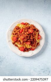 Spaghetti Bolognese Pasta With Cherry Tomatoes, Overhead Flat Lay Shot On A Slate Background