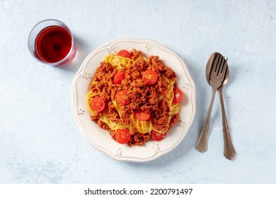 Spaghetti Bolognese, Pasta With A Meat Sauce, Overhead Flat Lay Shot With A Glass Of Red Wine