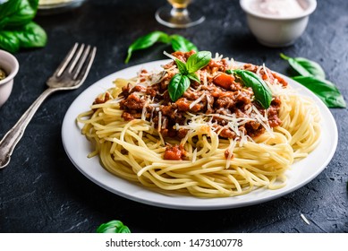 Spaghetti with bolognese sauce, grated parmesan cheese and fresh basil leaves
