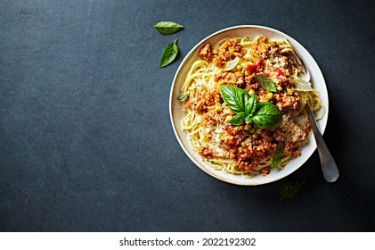 Spaghetti with Bolognese Sauce, Parmesan and Basil. Top view. Copy space