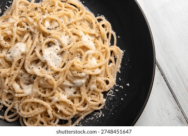 Spaghetti Cacio e Pepe, a typical recipe of pasta with cheese and black pepper, Italian Food 