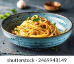 Spaghetti carbonara in modern ceramic bowl on dark slate table