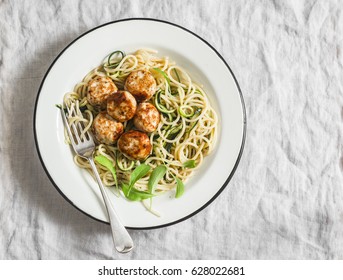 Spaghetti With Cheesy Chicken Meatballs And Zucchini Noodles. Delicious Lunch On A Light Background, Top View