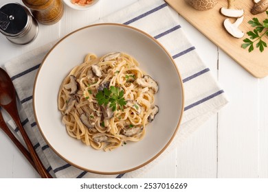 Spaghetti with creamy mushroom sauce,Pasta Linguine with mushrooms and parsley in white plate.Italian traditional dish.Top view. - Powered by Shutterstock