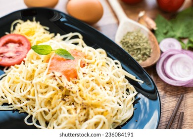spaghetti dinner with sauce and basil
