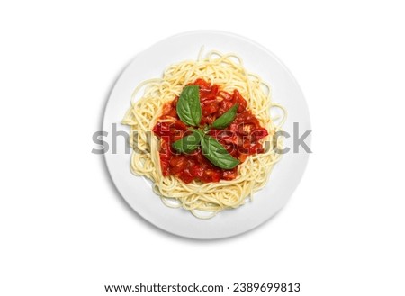 Spaghetti isolated on a white background, with Parmesan cheese and a fresh green basil leaves viewed from overhead on a white plate. Lunch meal from Italian pasta with tomato sauce