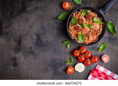 Spaghetti With Meatballs, Tomato Sauce. Background. Italian American Dish. Meatballs Pasta In A Pan. Space For Text. Overhead. Traditional Italian Cuisine. Dark Rustic Wooden Table. Dinner With Pasta