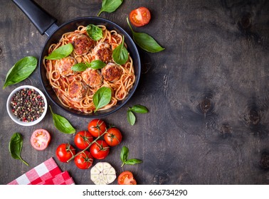 Spaghetti With Meatballs, Tomato Sauce. Background. Italian American Dish. Meatballs Pasta In A Pan. Space For Text. Overhead. Traditional Italian Cuisine. Dark Rustic Wooden Table. Dinner With Pasta