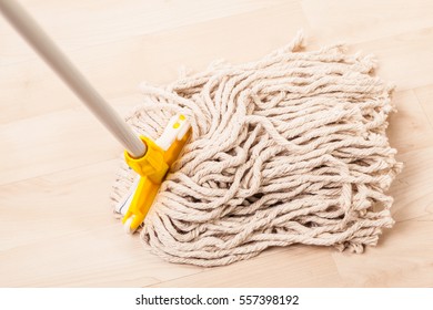 A Spaghetti Mop Head Cleaning A Light Wooden Floor