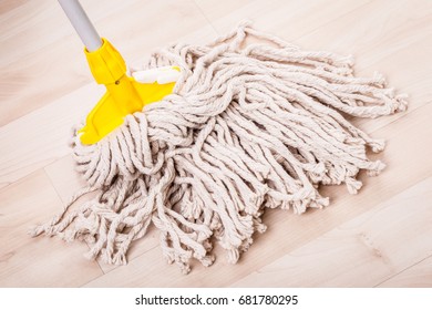 A Spaghetti Mop Head Cleaning A Light Wooden Floor