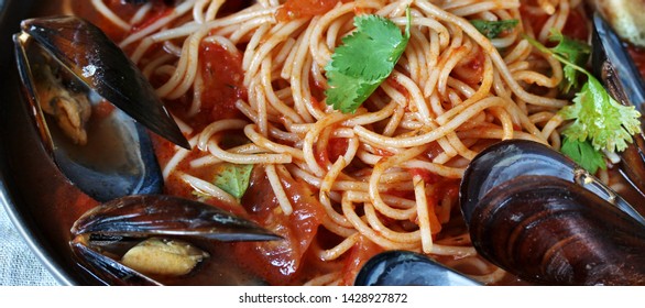 Spaghetti With Mussels, Tomato Sauce. Sea Food Meal. Mussels Marinara. Typical Dish Of Italian Pasta.