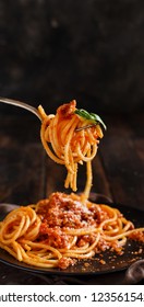 Spaghetti pasta with bolognese sauce with a fork close up