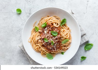 Spaghetti pasta with bolognese sauce and  parmesan cheese, top view.