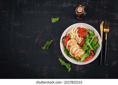 Spaghetti pasta, chicken burgers and salad in bowl. Chicken patties. Lunch. Top view, above, copy space - Powered by Shutterstock