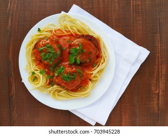 Spaghetti Pasta With Meatballs And Tomato Sauce In Plate Over Wooden Table, Top View