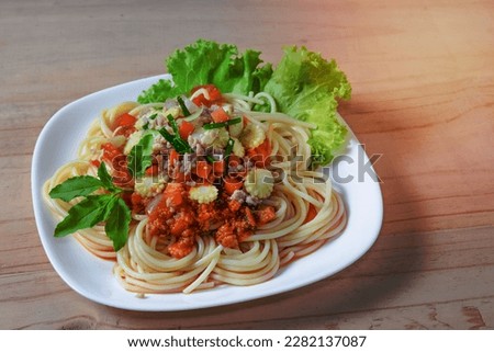 Spaghetti pasta with minced pork on wood background