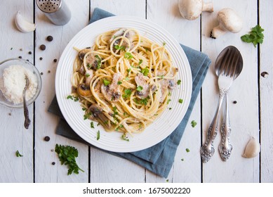 Spaghetti Pasta With Mushrooms, Creamy Sauce And Parsley On White Background