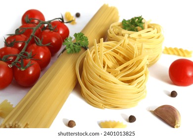 Spaghetti pasta and nests with vegetables lie on a white background. - Powered by Shutterstock