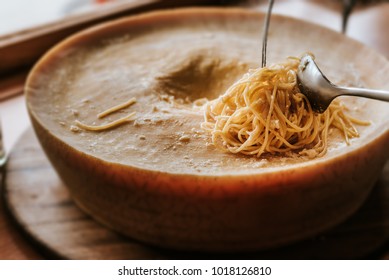 Spaghetti Pasta Preparation In A Parmesan Cheese Wheel.