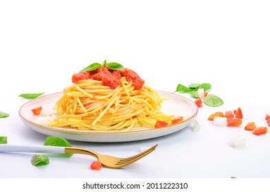 Spaghetti or pasta with tomato sauce and fresh green basil on a white plate with tomato isolated fork on a white background - top view - Shutterstock ID 2011222310