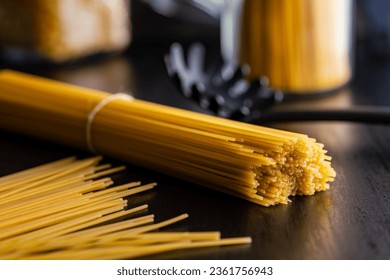 Spaghetti pasta. Uncooked italian pasta on a  black table.