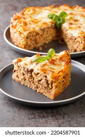 Spaghetti Pie With Ground Beef, Cheese, Tomato Sauce Closeup In The Plate On The Table. Vertical
