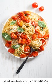 Spaghetti With Roasted Cherry Tomato And Fresh Basil In A White Plate