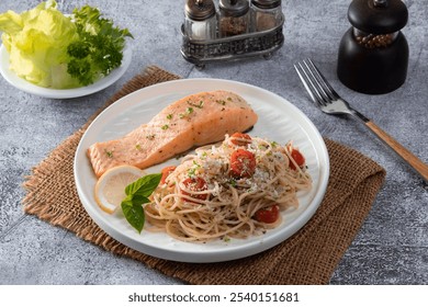 Spaghetti salmon steak and herbs in white plate on table background. - Powered by Shutterstock