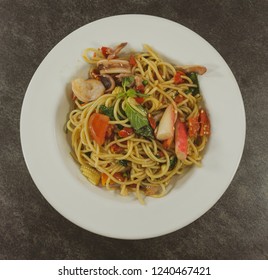 Spaghetti seafood  in a white dish on a black stone floor table.Top view with copy space. - Shutterstock ID 1240467421