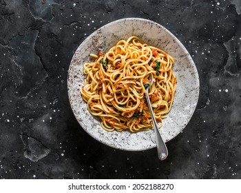 Spaghetti With Tomatoes Canned Tuna Sauce On A Dark Background, Top View