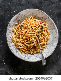 Spaghetti With Tomatoes Canned Tuna Sauce On A Dark Background, Top View