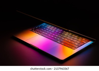 Spain, 03, 20, 2022.Macbook Pro 2021 with glowing colorful reflection.