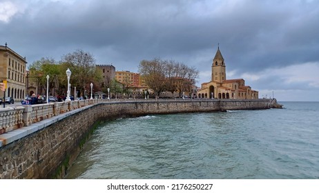 Gijón, Spain; April 2022: Church Of San Pedro, In The Bay Of San Lorenzo Beach, From The Promenade