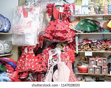 SPAIN - APRIL 30, 2018: A Souvenir Shop Selling Flamingo Dancer Gowns And Spanish Souvenirs In Granada, Andalusia, Spain.